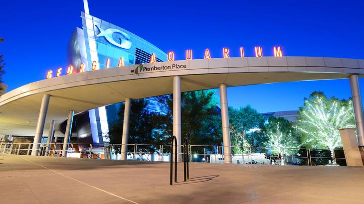 The exterior of an aquarium with a "Georgia Aquarium" sign on it The exterior of an aquarium with a "Georgia Aquarium" sign on it