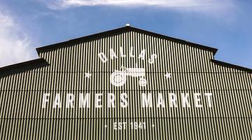 A barn with a Dallas Farmers Market sign on it