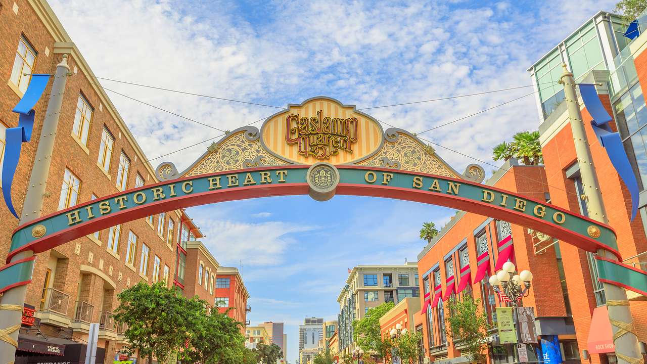 A sign that says "Gaslamp Quarter" with buildings on either side under blue sky