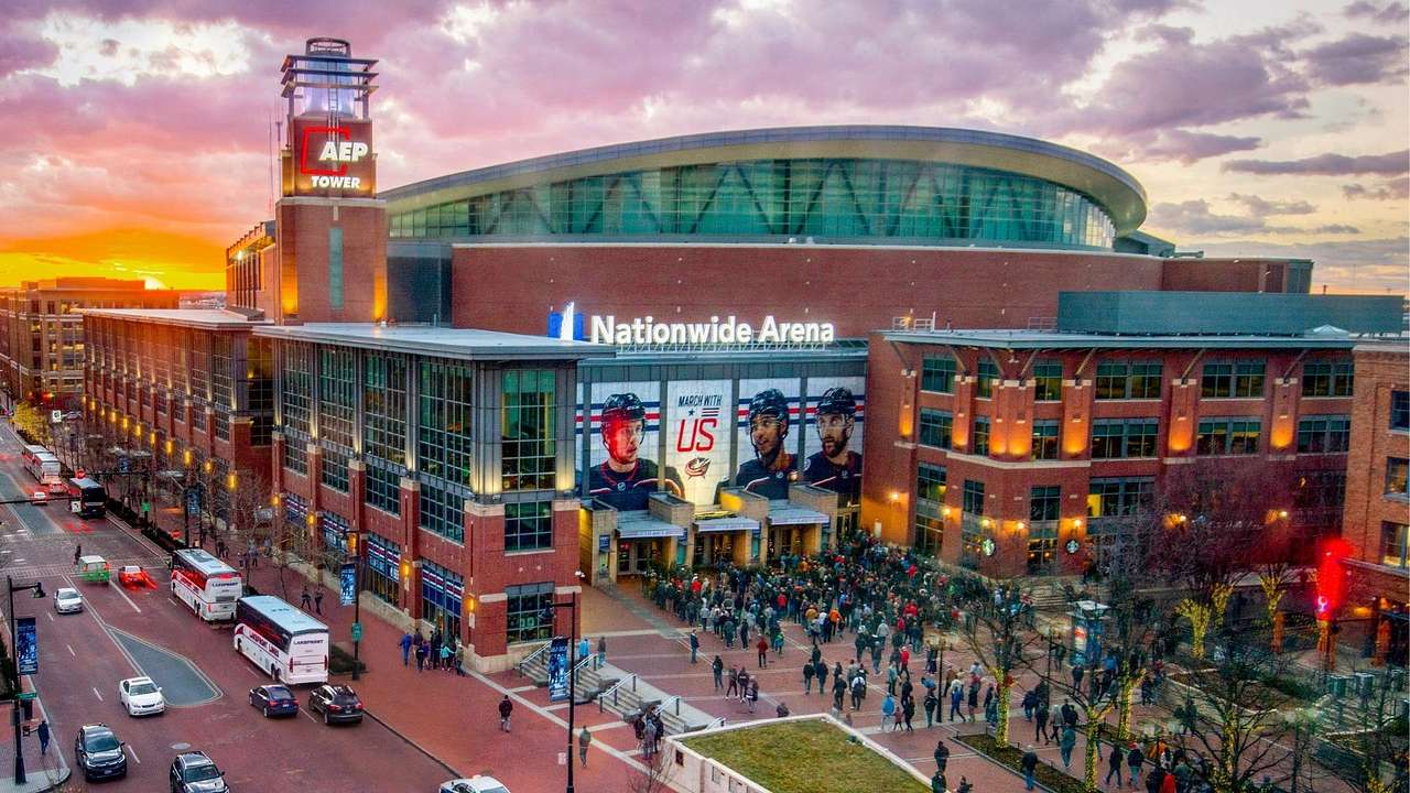 A sports arena with a "Nationwide Arena" sign on it and people going inside