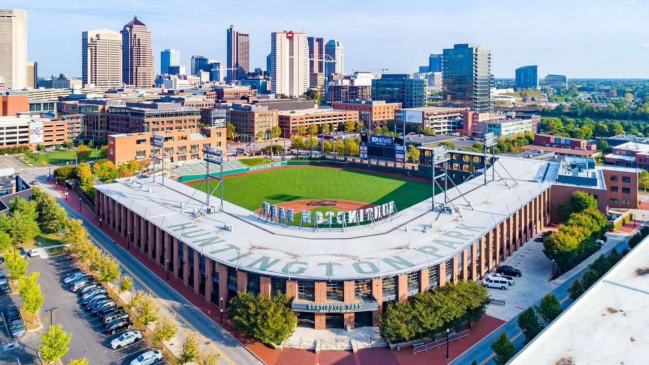 Aerial view of a baseball stadium with a skyline behind it