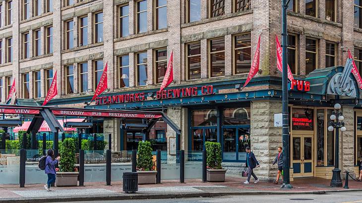 The exterior of a restaurant with a red "Steamworks Brewing" sign The exterior of a restaurant with a red "Steamworks Brewing" sign