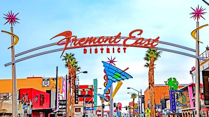 Colorful neon signs, including a martini glass and a "Fremont East District" sign