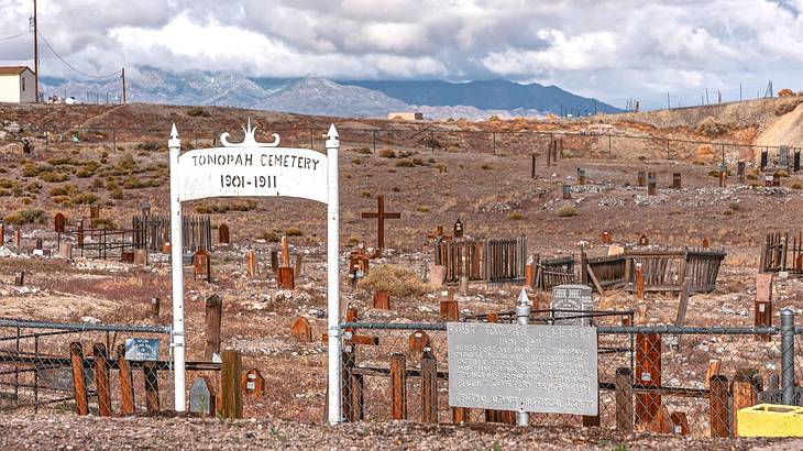 An old fashioned cemetery n a desert with a white archway at the entrance An old fashioned cemetery n a desert with a white archway at the entrance