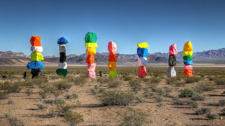 Seven towers of different colored stacked rocks in the desert