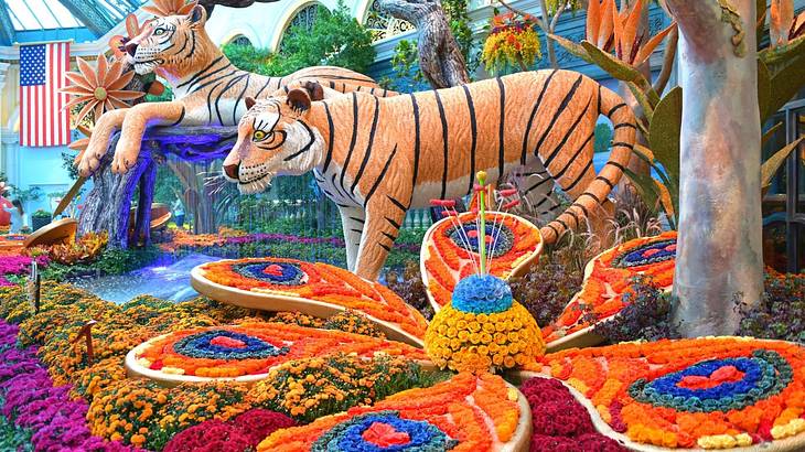 A garden with colorful flower displays and tiger statues