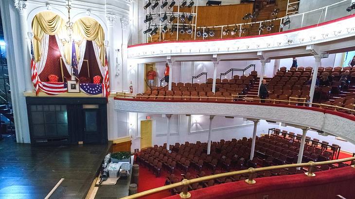 An old-fashioned theater with red seats and white balconies An old-fashioned theater with red seats and white balconies