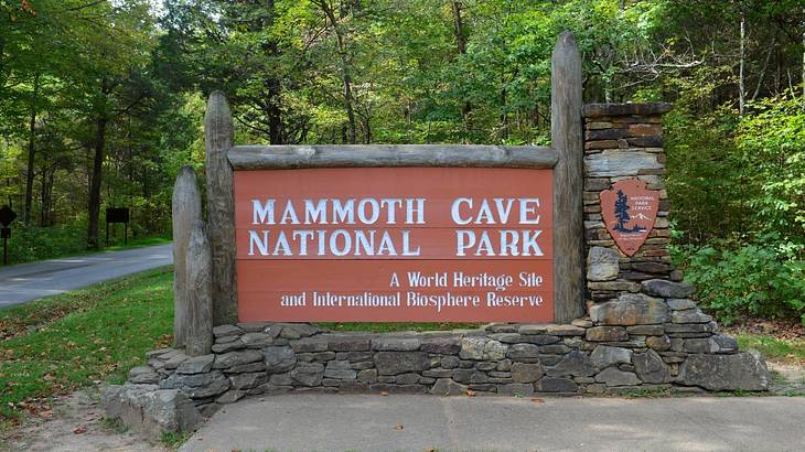 A sign within a forest that says "Mammoth Cave National Park"