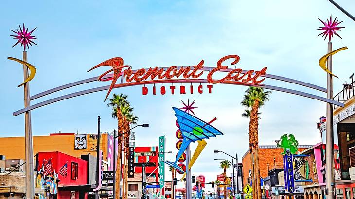 A brightly colored sign that says "Fremont East" with neon signs surrounding it