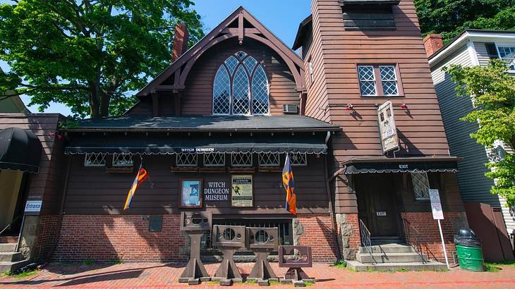 An old-fashioned wooden building with a "Witch Dungeon Museum" sign