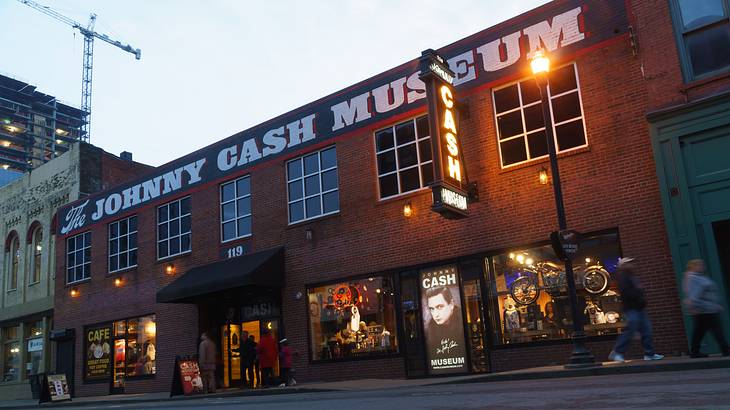 A red brick building that says "The Johnny Cash Museum" with a street in front