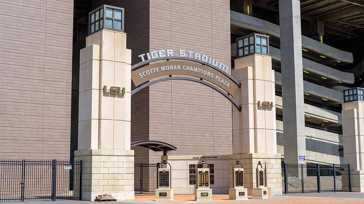 The entrance to a stadium with an arch and a sign that says "Tiger Stadium"