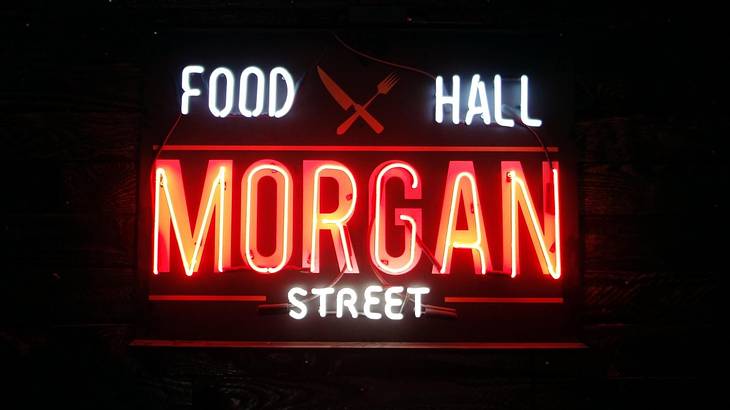 A neon sign that says "Morgan Street Food Hall" on a black background