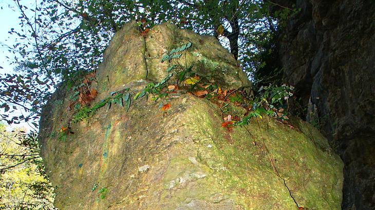 An up-close shot of a large rock balancing on a stack of rocks