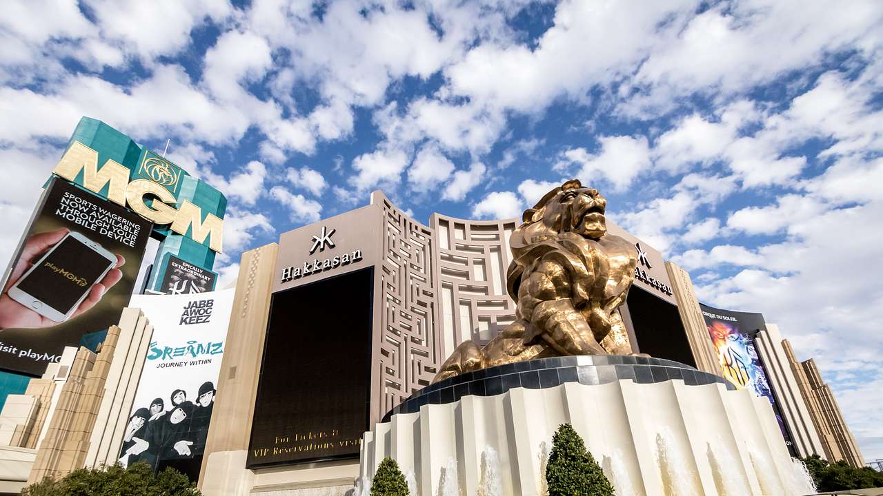 A hotel with MGM sign and a gold lion statue in front of it