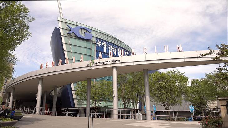 A building with a "Georgia Aquarium" sign and trees around it