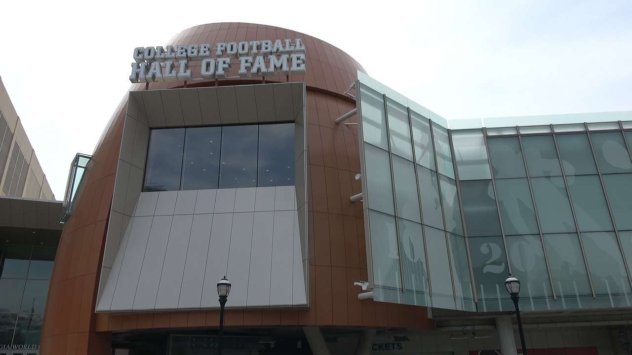 Looking up at a glass modern building, with a "College Football Hall of Fame" sign