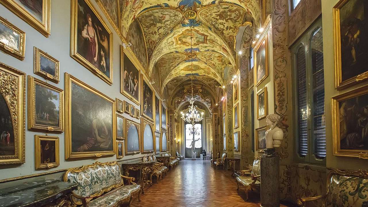 The interior of an art gallery with painted ceilings and artworks on the walls