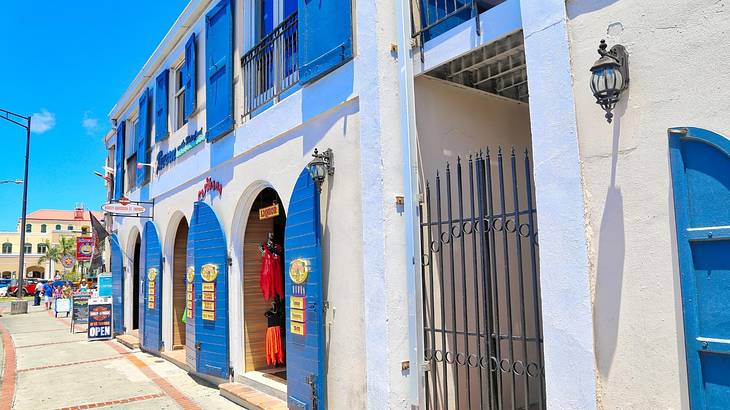 A street with a building with blue window coverings