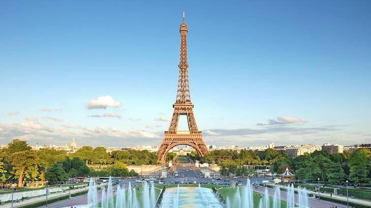 The Eiffel Tower with water features in front of it and tree surrounding it