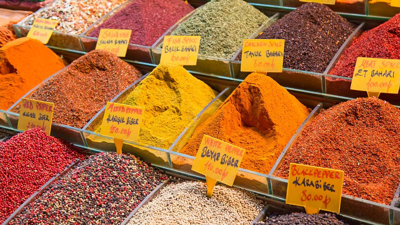 Various spices of different colors on display on a market stall