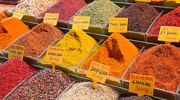 Various spices of different colors on display on a market stall
