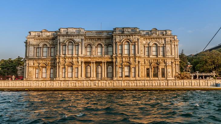 An ancient palace with arched windows overlooking water