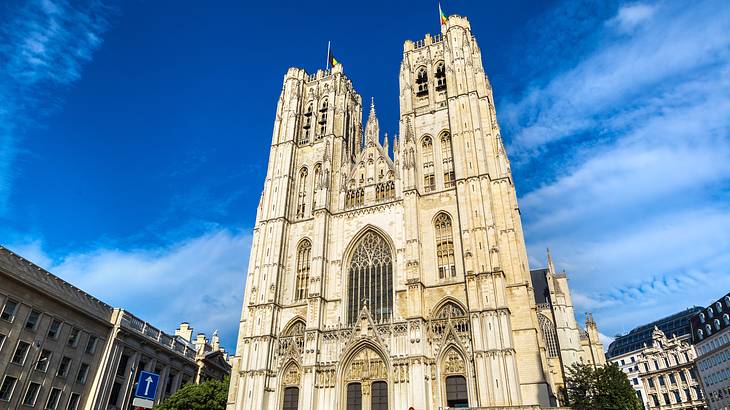 Looking up at a Gothic cathedral building against a partly cloudy sky Looking up at a Gothic cathedral building against a partly cloudy sky
