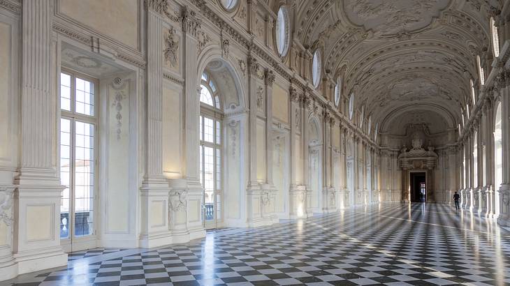 The interior of a luxurious royal palace with a black and white checkered floor