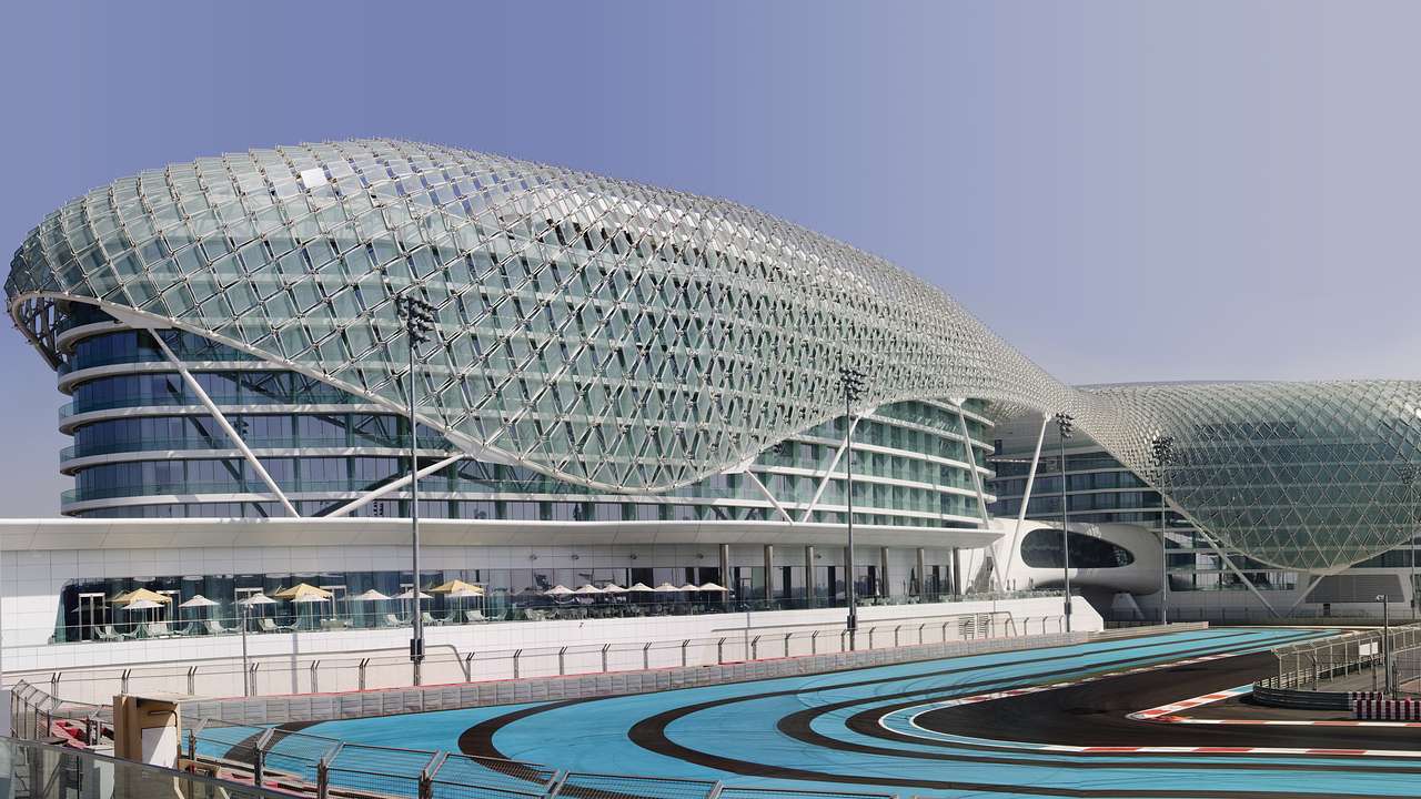 A Formula 1 race track next to a contemporary glass building