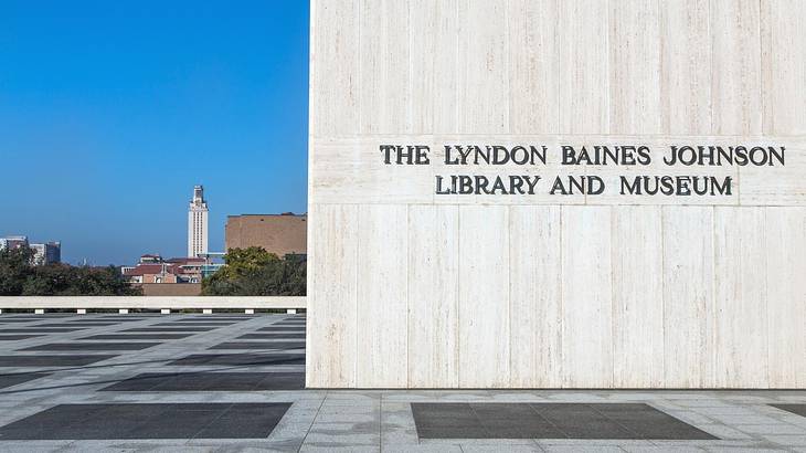A building wall with a sign that says "The Lyndon Baines Johnson Library and Museum"