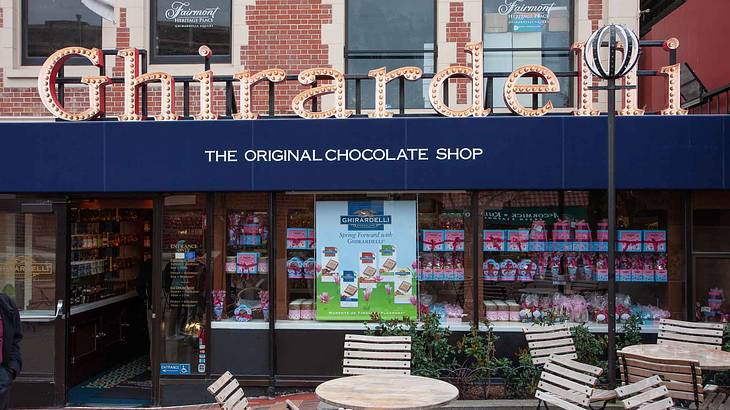 A chocolate storefront with the name "Ghirardelli" on the front