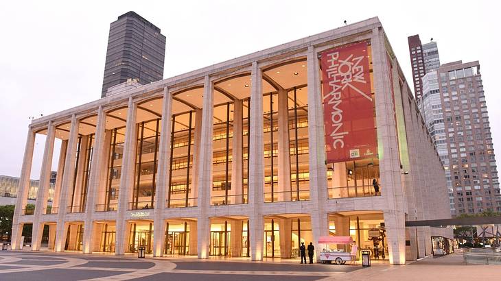 A building with columns and a New York Philharmonic banner hanging on it