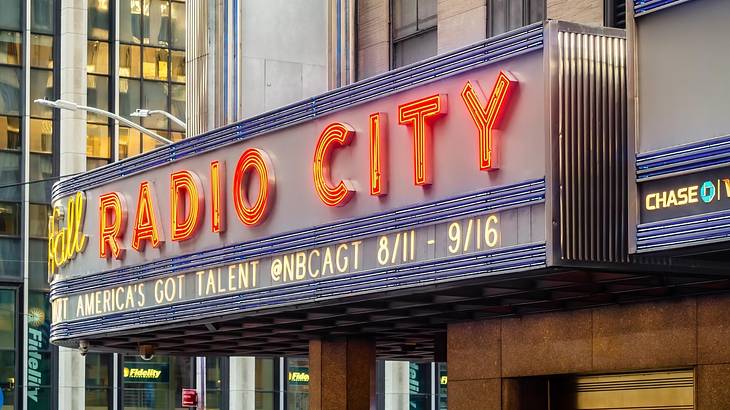 A sign on a building that says "Radio City" in red neon letters