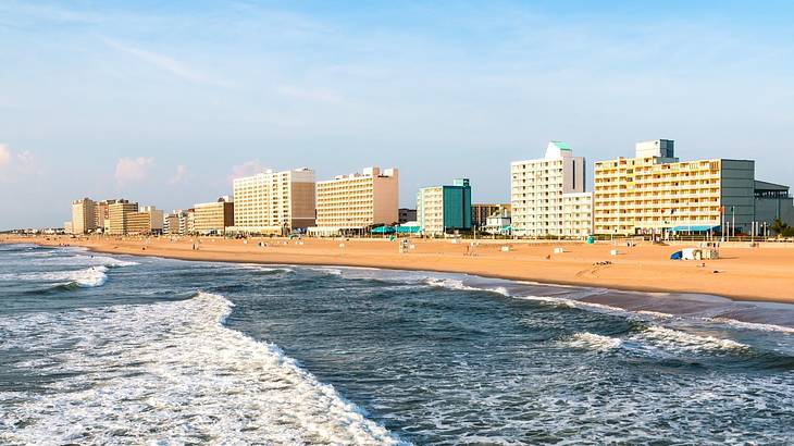 High-rise buildings overlooking a beach with shallow sea waves
