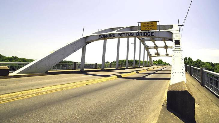 A white bridge over a road that says Edmund Pettus Bridge