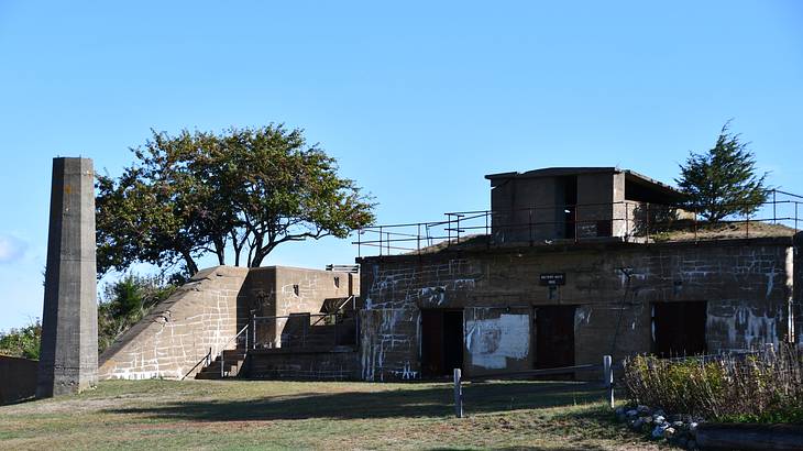 An old abandoned fort with greenery around on a clear blue day