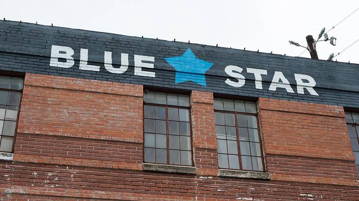 A brick building with a blue star on it and "Blue Star" in white A brick building with a blue star on it and "Blue Star" in white