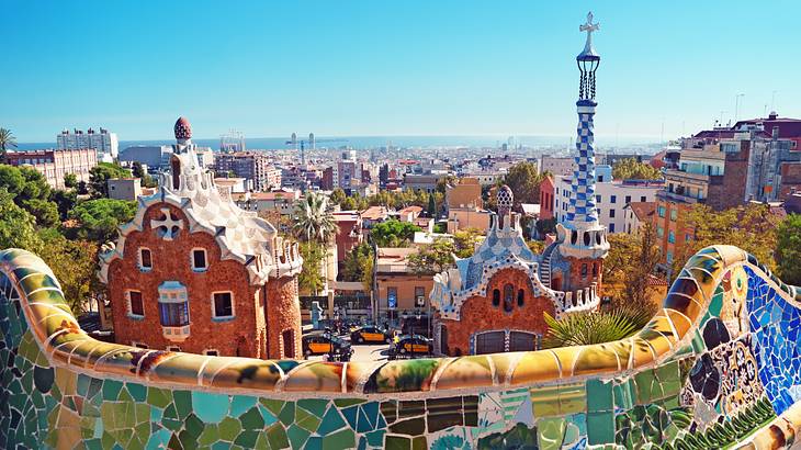 Looking over a mosaic-decorated parapet at houses and buildings on a clear day