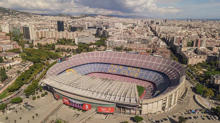 Aerial view of a football stadium surrounded by trees and buildings