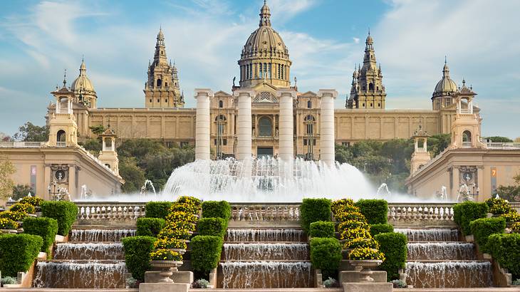 A multi-level fountain below a Spanish Renaissance structure