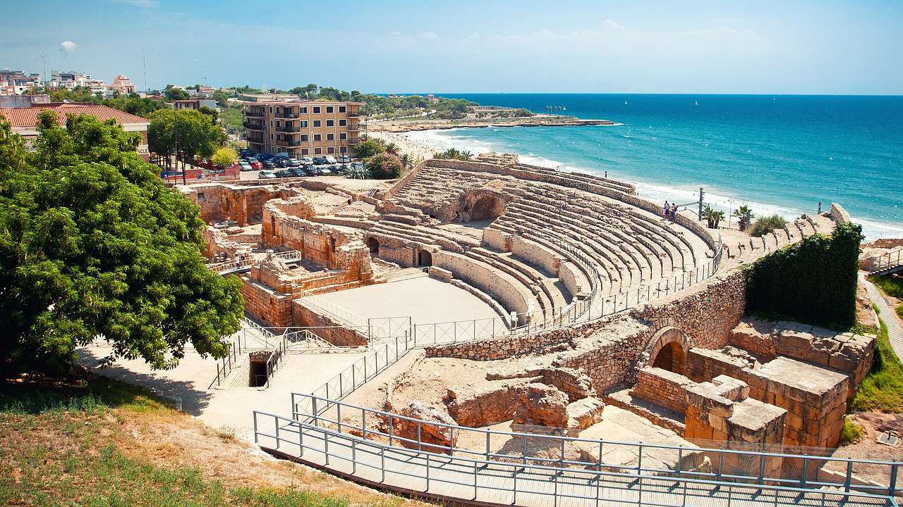 View from the top of ruins of a Roman amphitheatre overlooking a nearby sea