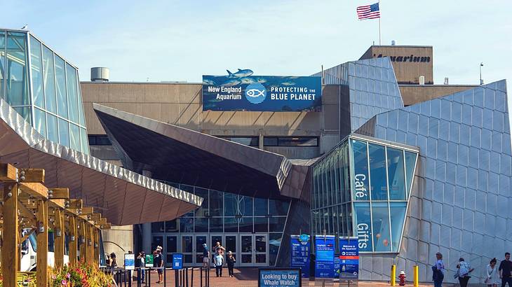 A modern-looking building with blue banners and an American flag on it A modern-looking building with blue banners and an American flag on it
