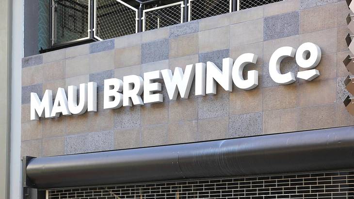 A sign that says "Maui Brewing Co" on a building