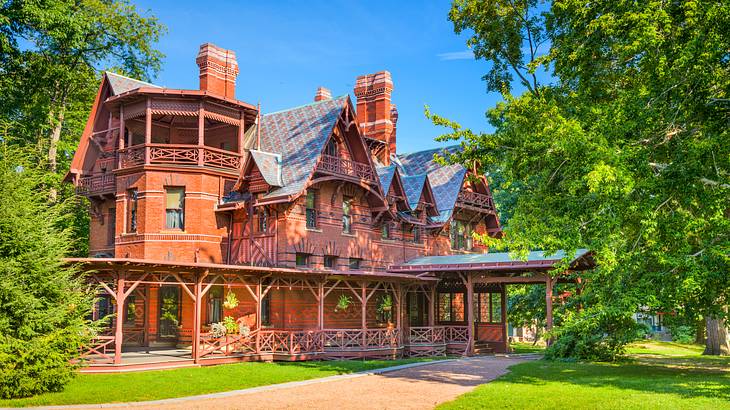 A pathway leading to a wooden vernacular house with Victorian architecture A pathway leading to a wooden vernacular house with Victorian architecture
