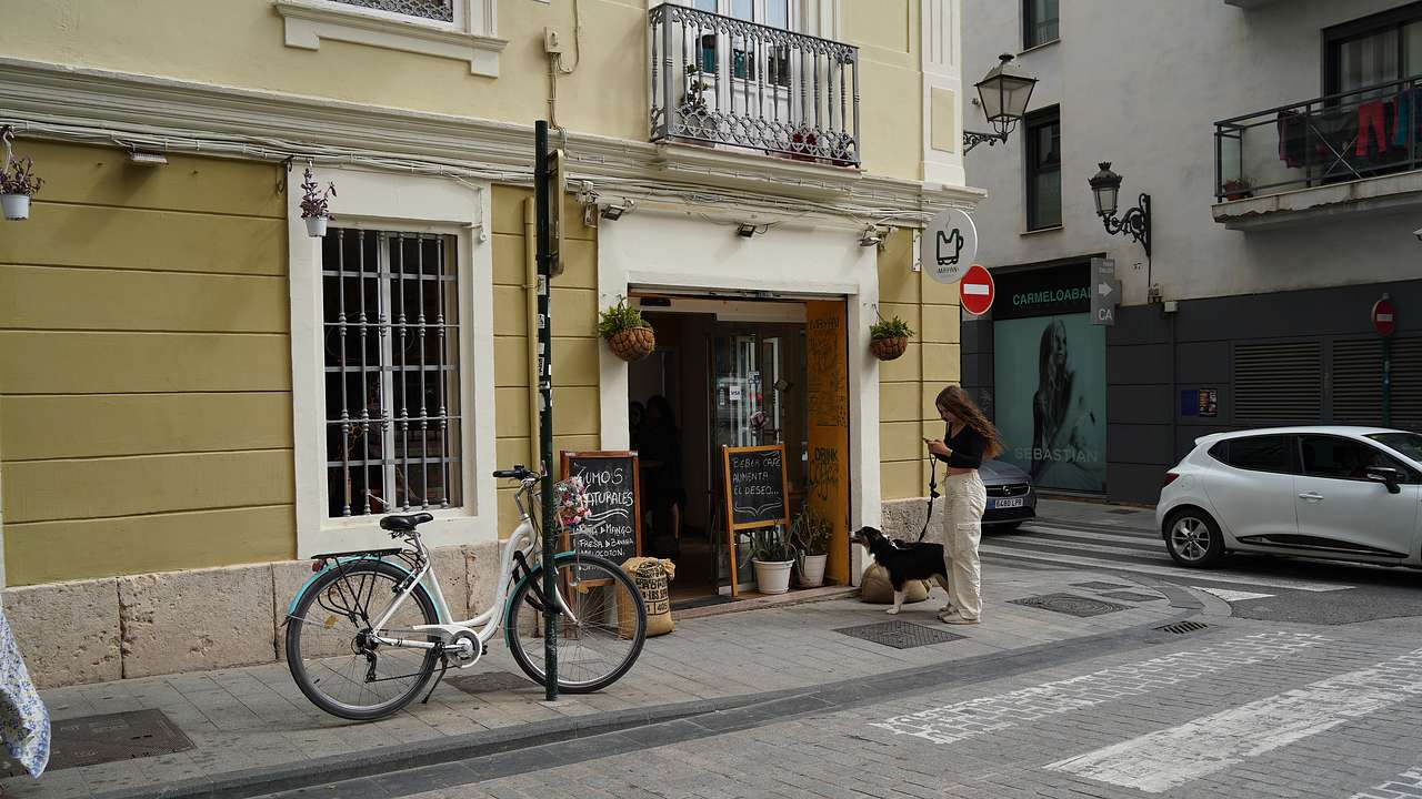An entrance way to a coffee shop with a bicycle and signage at the front