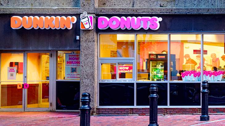 The entrance way to a Dunkin' Donuts on an inner city street