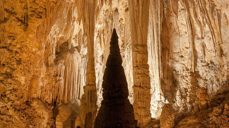 Stalactites and stalagmites inside an illuminated cave