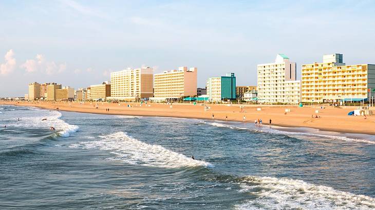 The ocean next to a sandy beach and beachside apartment buildings and hotels