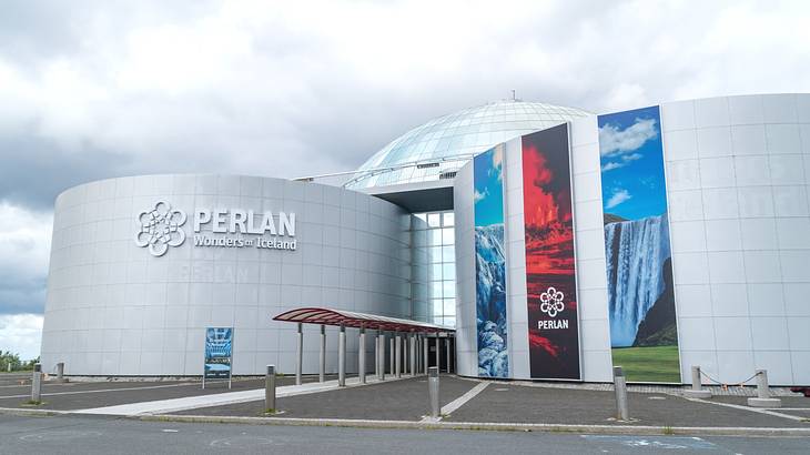 Two round structures with a "Perlan" sign on one and colorful banners on the other